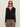 A woman in red sunglasses and leopard print pants models the Sanctuary Clothing lightweight ribbed cardi in black, standing against a plain light background.